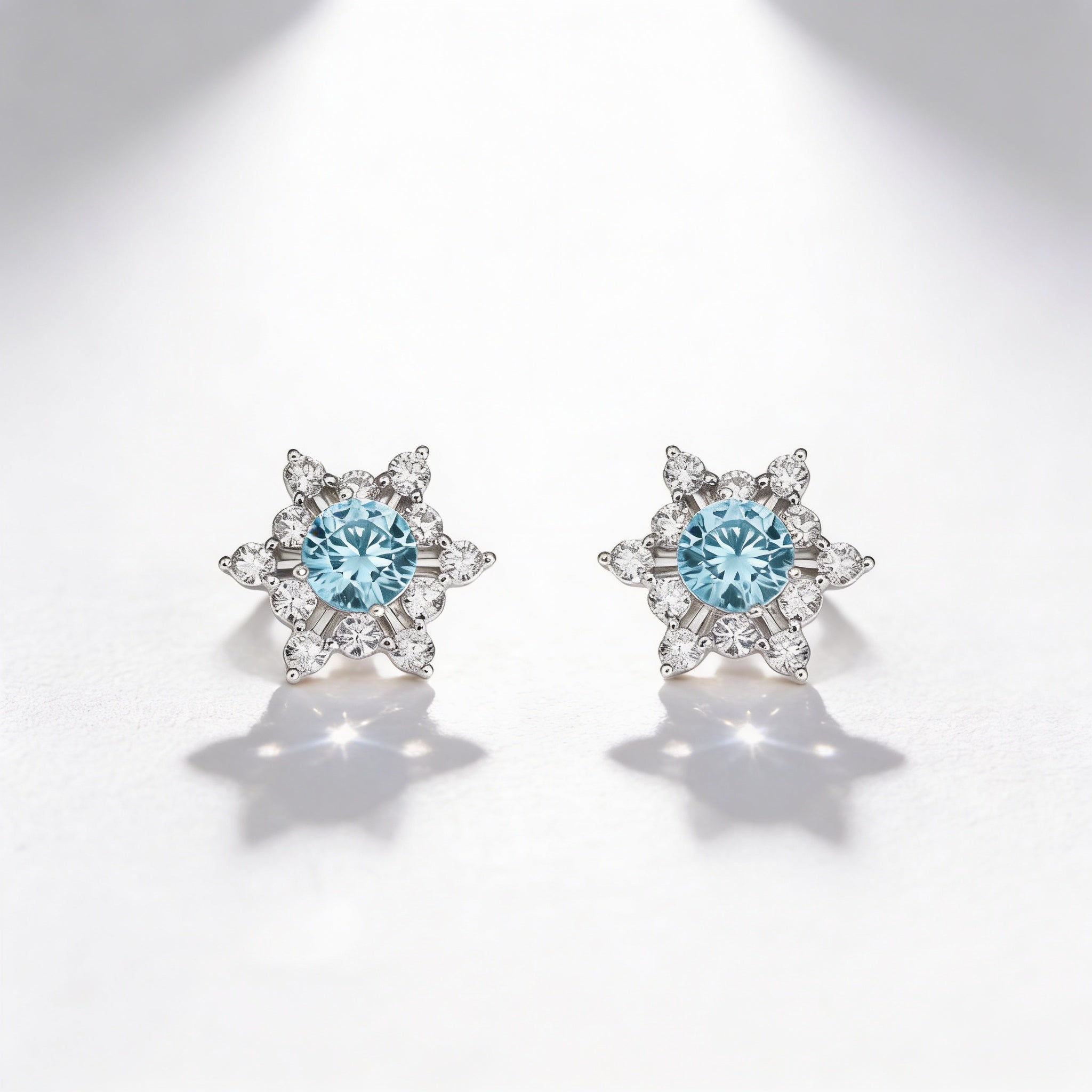 Snowflake Stud Earrings with Light Blue Stone – 925 Silver