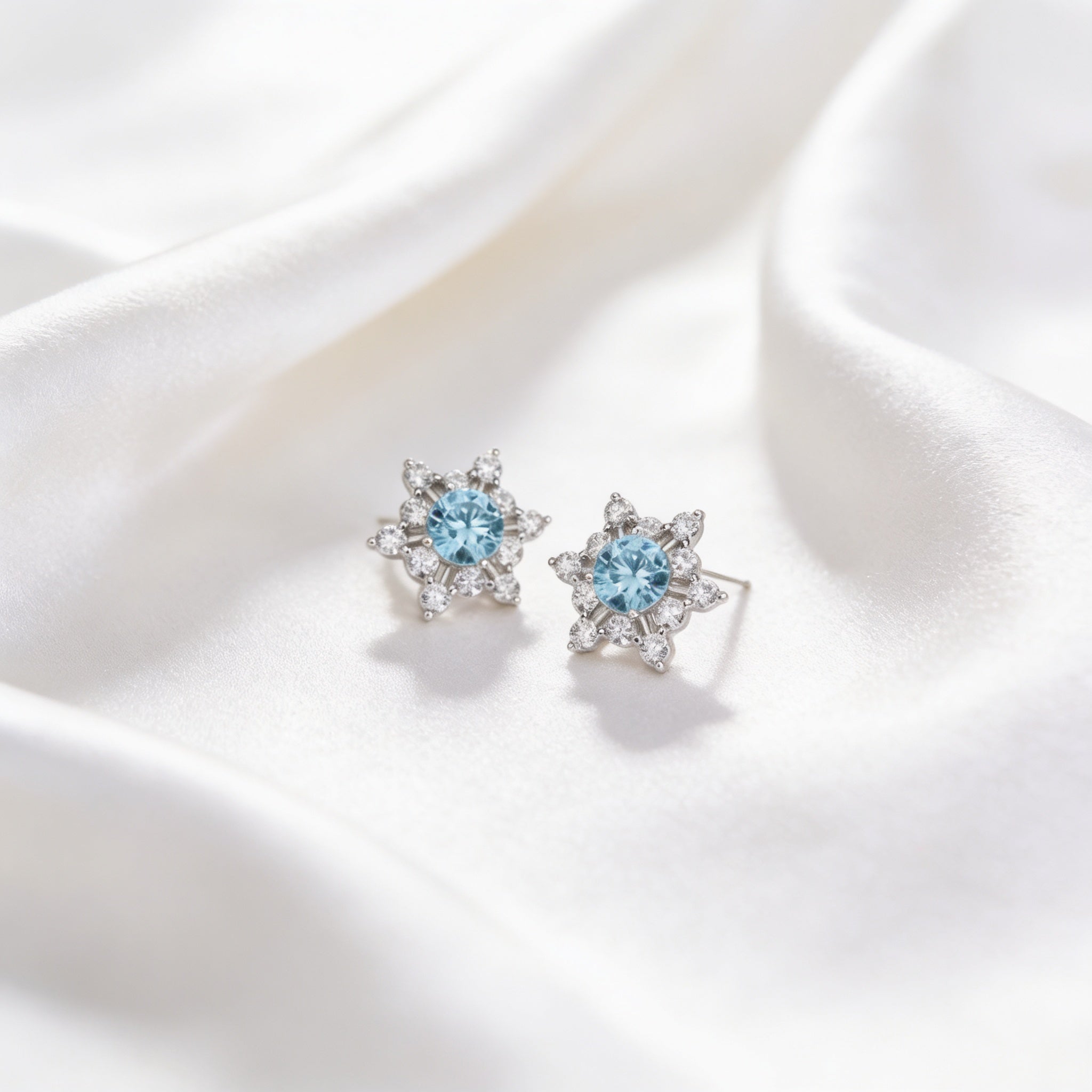 Snowflake Stud Earrings with Light Blue Stone – 925 Silver