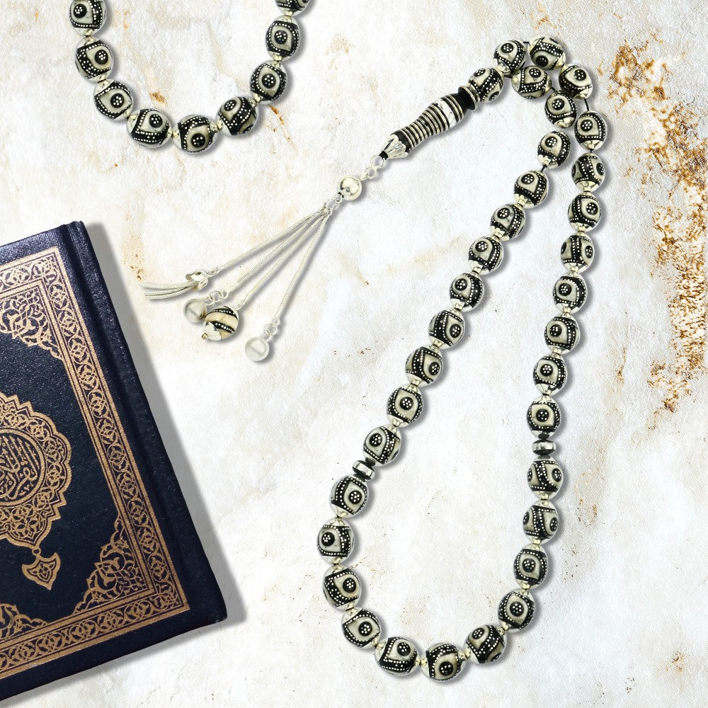 Prayer beads made of luxurious black coral, inlaid with silver, turquoise, and ivory, 33 beads.