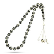Prayer beads made of luxurious black coral, inlaid with silver, turquoise, and ivory, 33 beads.