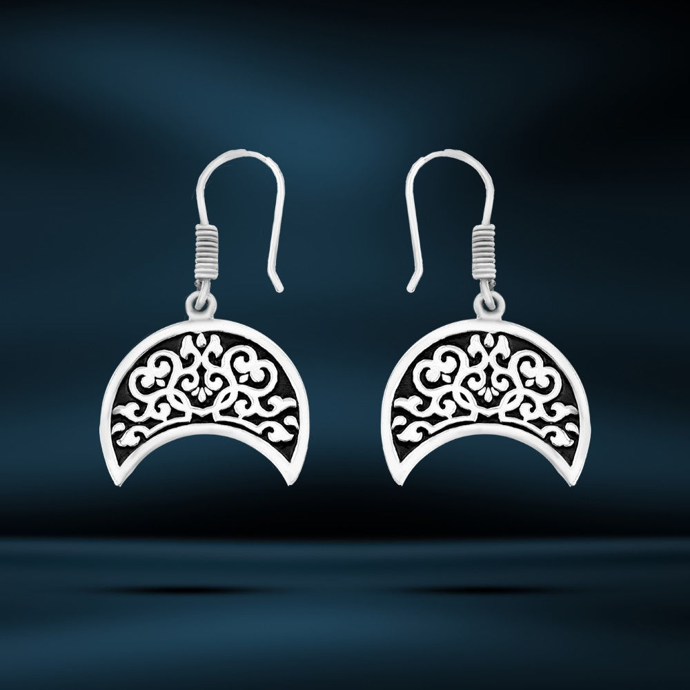 Silver earrings with an ornate Arabic design