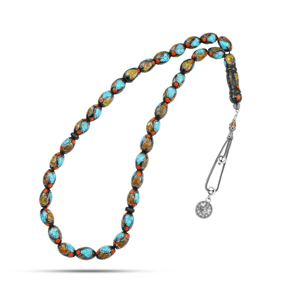 A rosary of natural jet, inlaid with silver, turquoise, and amber, 33 beads.