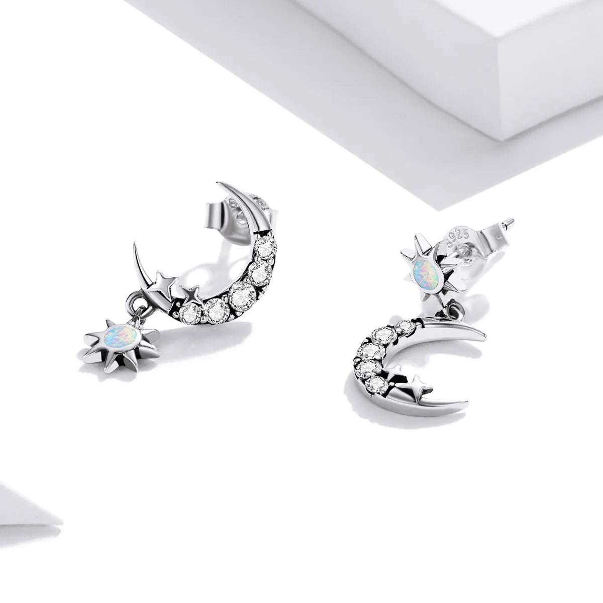925 silver hoop earrings with a crescent moon design and dangling star