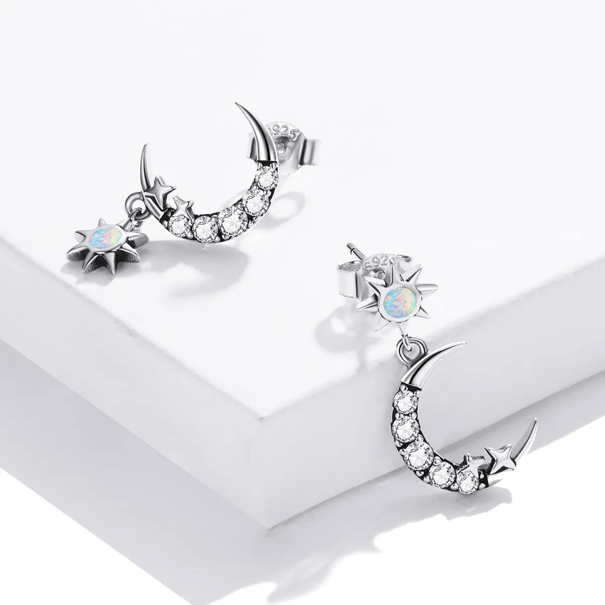 925 silver hoop earrings with a crescent moon design and dangling star