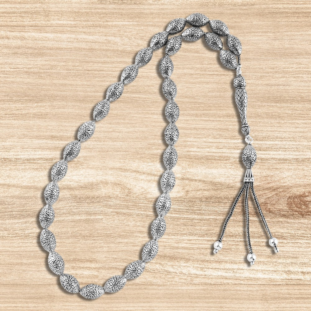 999 silver prayer bead with oval-shaped beads engraved with a precise geometric pattern