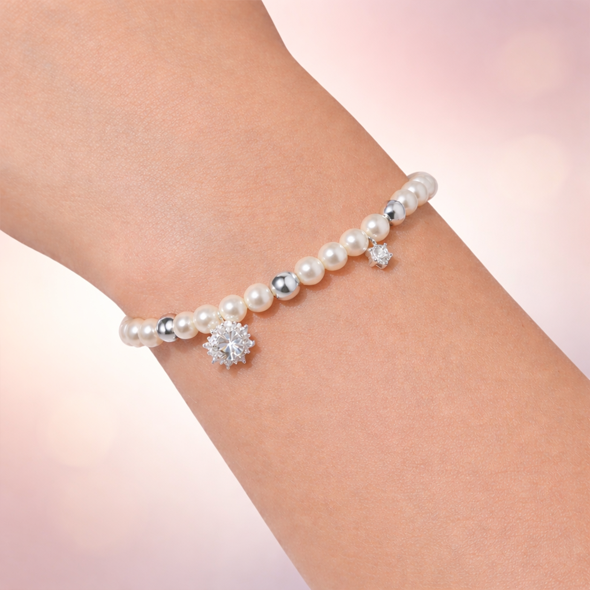 A pearl bracelet with a dangling sparkling stone, crafted from 925 silver.